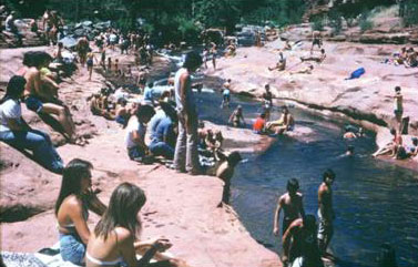 Another picture of slide rock with a lot of people in the area.