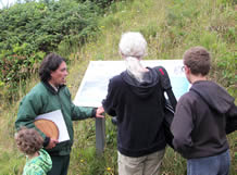 Field Ranger along a trail at the Cape talking to visitors by interpretive sign