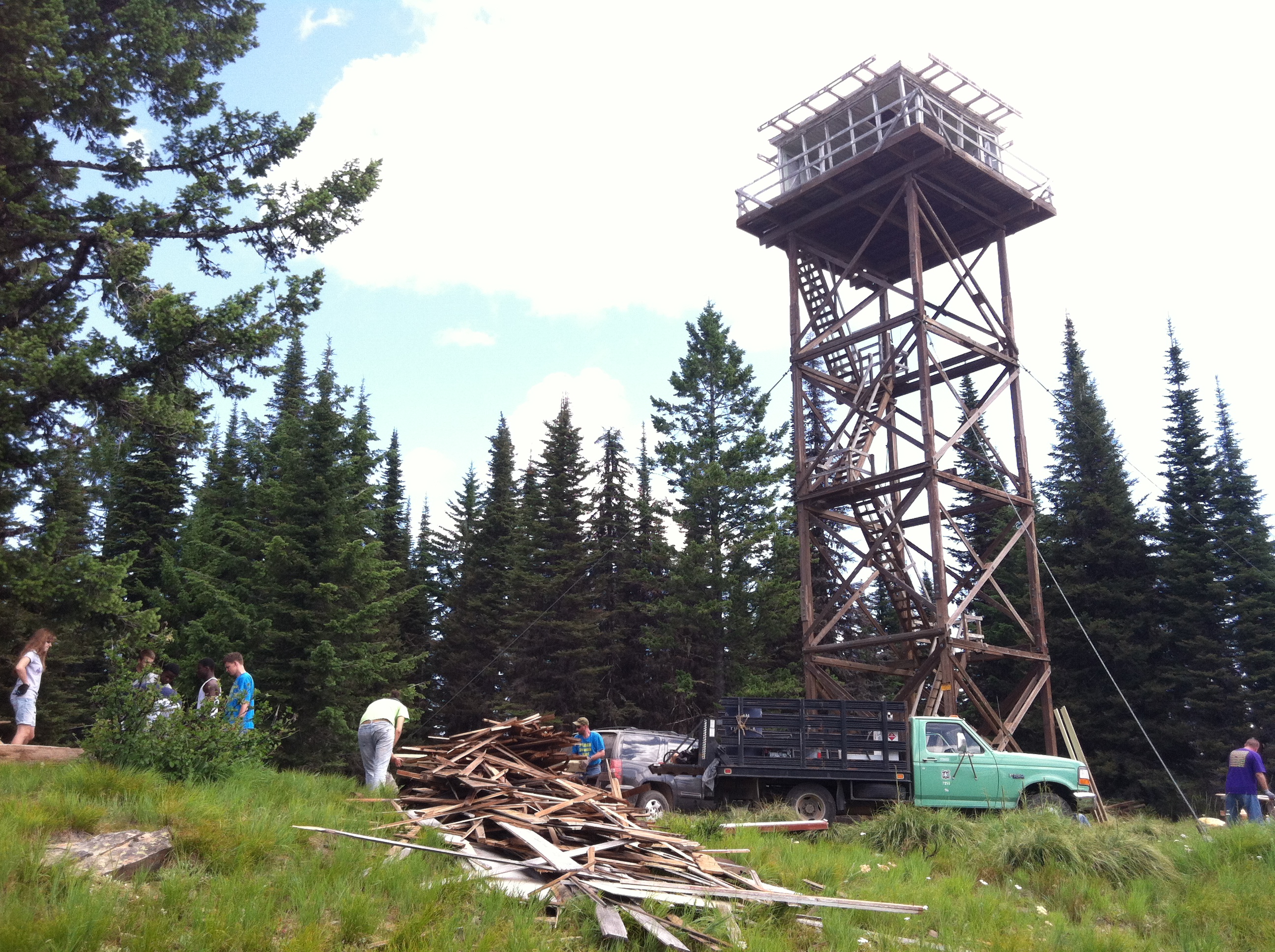 Volunteers work on Spyglass Peak renovating historic buildings and repairing vandalism.