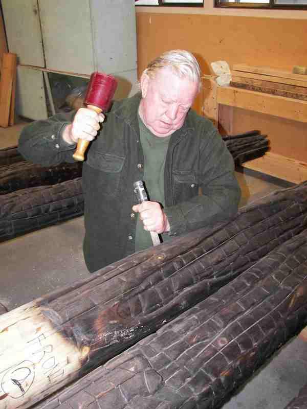 Hal Payne sculpting the new logs