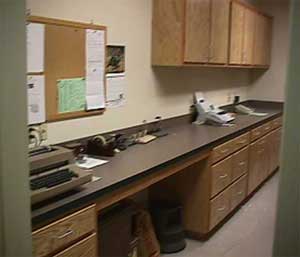 Photo of a work area with cabinets and a counter top.