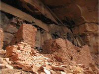 A cliff dwelling showing stacked adobe bricks