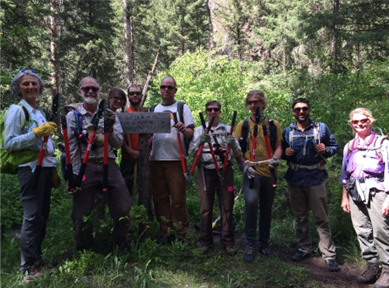 Image of a group of trail workers with their tools.