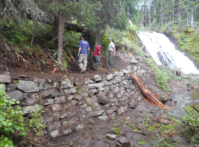 Image of trail workers working on a retaining wall.