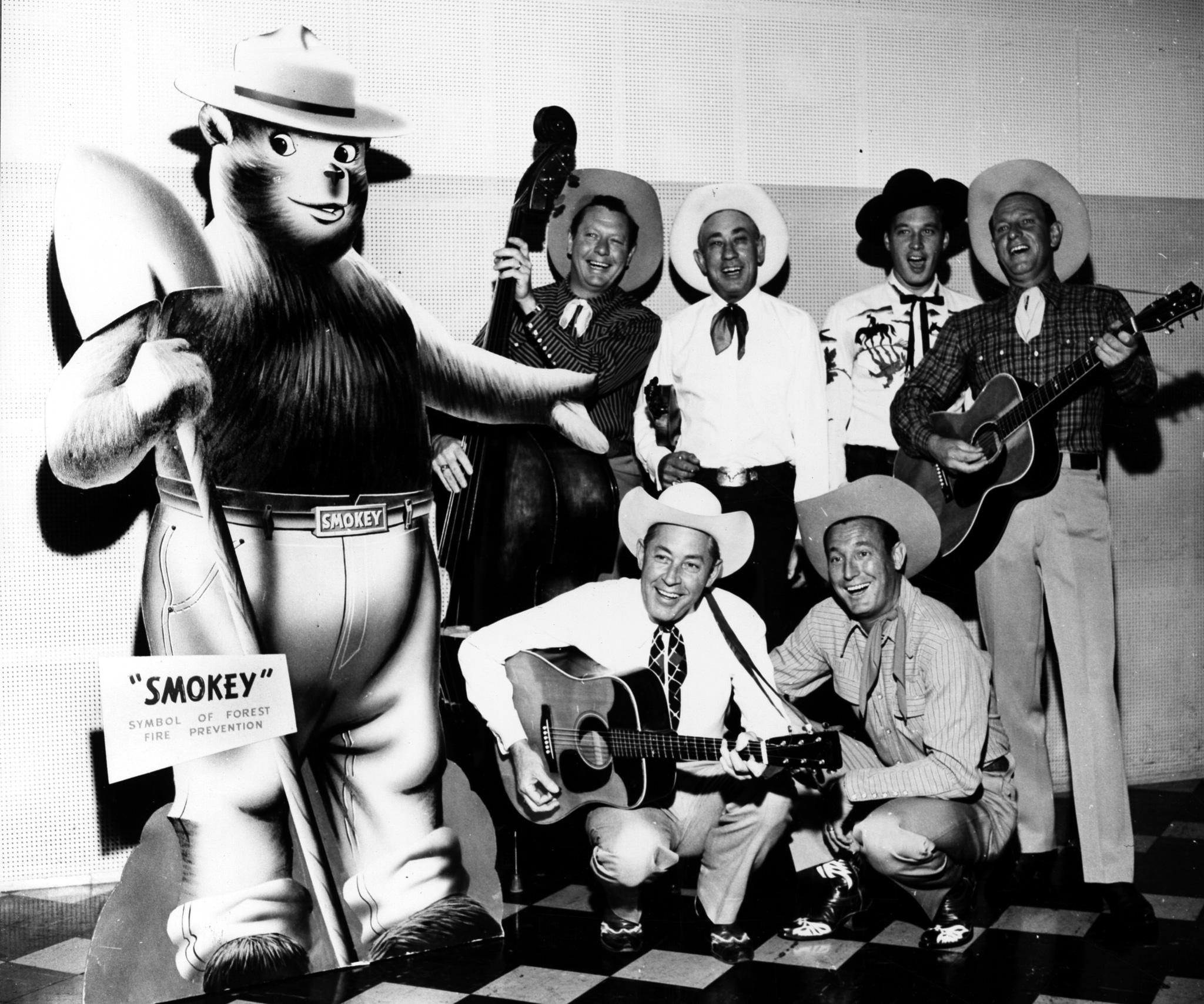 Smokey Bear posing with a group of musicians in the 1950's.