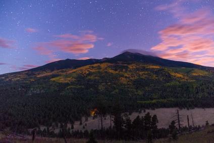 The stars come out as the sun sets on fall color on the San Francisco Peaks, Coconino National Forest, Arizona viewed from the White Horse Hills along Forest Road 418, October 1, 2016. (Forest Service photo by Deborah Lee Soltesz)