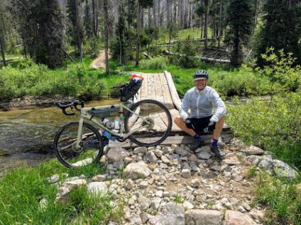 Visitor Map fan Bob Huber pauses for a photo during his recent bicycle trip tour of national forests in Idaho.