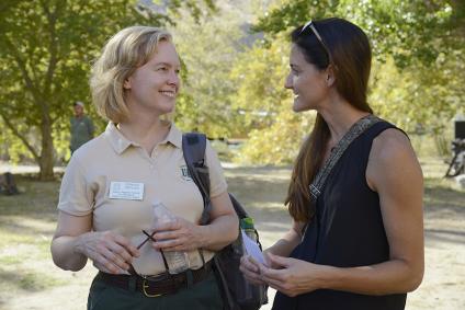 Uniformed Forest Service employee talks to a Peace Corps volunteer.