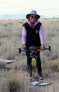 Paulette Ford holding a drone.