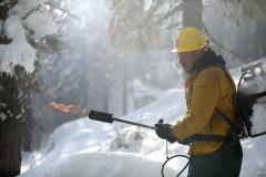 Firefighter Asteban Avitia testing a propane torch while on a winter pile burn project.