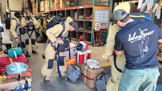 The California Smokejumpers preparing their gear and parachutes.