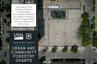 USDA Forest Service, Urban and Community Forestry Grants graphic showing an aerial view of a community playground and basketball courts. Subtext reads "100 percent of the benefits will flow to disadvantaged communities to address the negative impacts of climate change, extreme heat, and inadequate tree canopy."