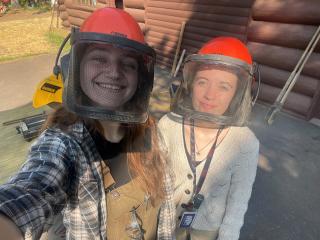 Two young women take a selfie while wearing proctective gear