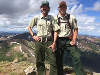 two men in forest service uniforms in the backcountry