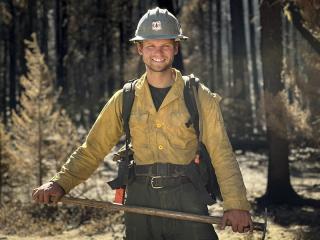 young wildland firefighter holder ax