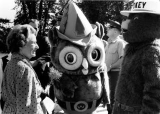 Image shows First Lady Betty Ford standing in front of Smokey Bear and Woodsy Owl.