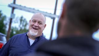 A person in blue shirt smiling.