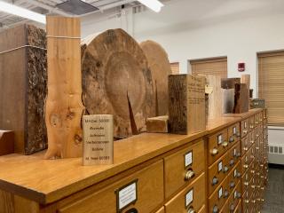 Large smaples of wood placed on top of a wood filing cabinet