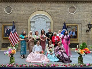 Group photo: Some of the participants are wearing traditional Chinese dresses.