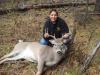 A picture of Sandra Broncheau-Mcfarland with a white tail buck taken during a hunt.