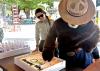 Smokey Bear cuts a 100th anniversary cake with a female Forest Service employee by his side.