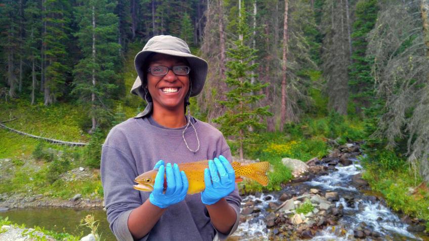 Woman holding cutthroat trout