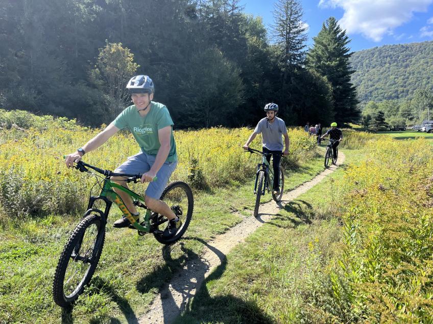 Students mountain biking a trail in Green Mountain National Forest.