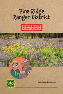 The cover of the Junior Ranger Activity Book for the Pine Ridge Ranger District has flowers, the main character, and his horse.