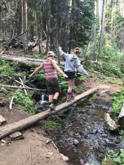 children walking across a water crossing