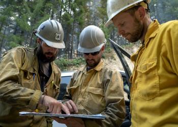 Firefighters reviewing a map