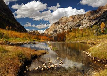Photograph of a river headed through a mountain range