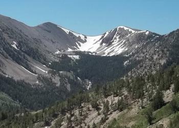 Photograph of a mountain range with a little snow