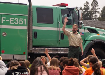 Forest staff in front of fire truck presenting to group of students