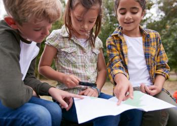 Kids reading a map.
