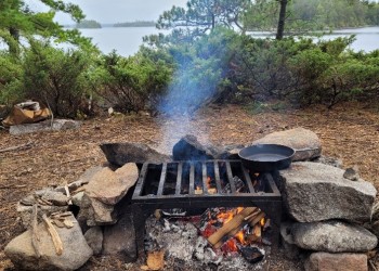 a fire grate surrounded by rocks in the Boundary Waters Canoe Area Wilderness
