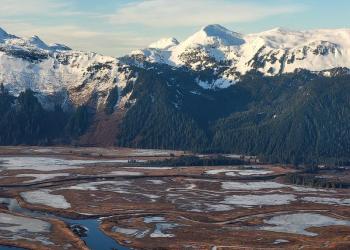 An aerial view of wetlands and mountains.
